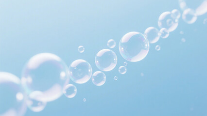 Many soap bubbles float on a light blue background