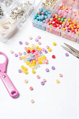 Colorful Friendship Bracelet Making Kit - Beads, Letter Charms, and Threads on White Background for International Friendship Day Crafting Projects