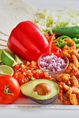 spicy shrimp tacos with avocado and bell pepper