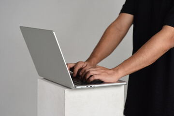 Man working in a light gray laptop