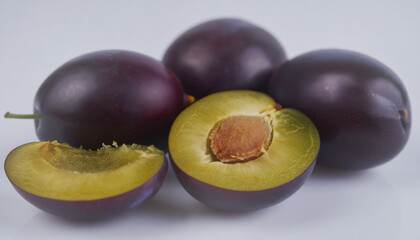 Fototapeta premium damson plum Purple cut in yellow halves on white background.