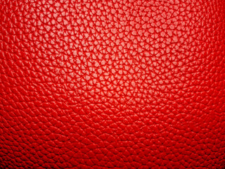 Rich red leather texture with a uniform pattern of small, raised bumps creating a luxurious,...