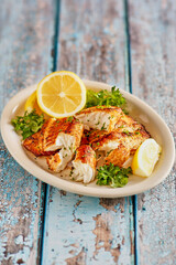 whiskey glazed, cast iron seared fish fillets with fresh lemon and parsley