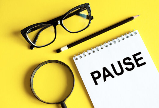Notepad With Pause. Business Concept Yellow Desk