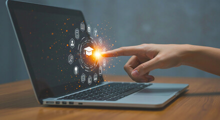 Person touching a laptop screen with education icons surrounding a graduation cap in the center