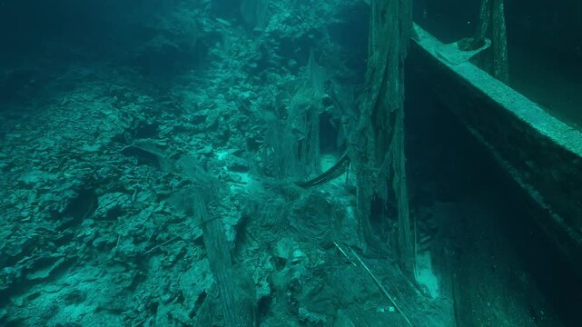Large ghost fishing nets drape a coral wall near a sunken trawler wreck in the Red Sea. A disturbing sign of marine pollution. Check my portfolio for more ghost net footage.