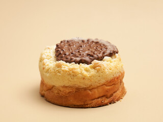 Freshly baked pastry with topping, on beige background