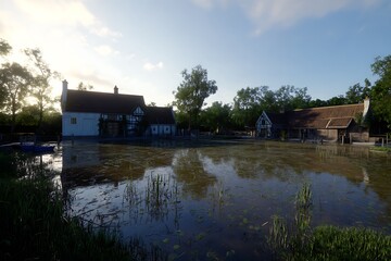 Fototapeta premium Reflection pond at historic rural buildings