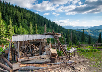 Woodpile shed in Carpathian mountains. Beautiful idyllic landscape