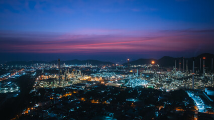 Aerial view oil and gas storage tank, oil refinery factory plant at night form industry zone, Oil refinery petrochemical plant factory at twilight, Business oil and gas industrial factory 