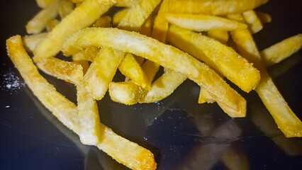 french fries on a black background