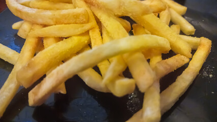 french fries on a black background