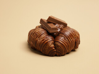 Freshly baked pastry with topping, on beige background