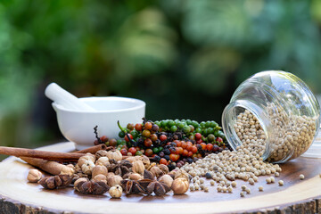 Vibrant peppercorns and aromatic herbs: nature's essence for healthy living and flavorful dishes. Perfect for culinary and wellness themes.