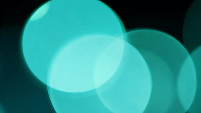 Turquoise bokeh rings rotate clockwise smooth K loop offering elegant overlay wedding films fashion promos experiential art pieces needing gentle luminous movement