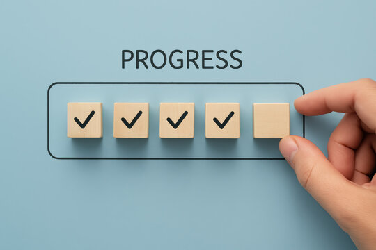 A places the final wooden block in a series check marks symbolizing steady progress and task completion in business