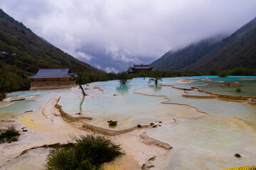 Huanglong National Park, blue water in limestone wells is a landmark for tourists to visit in Ngawa Tibetan and Qiang in Sichuan, China