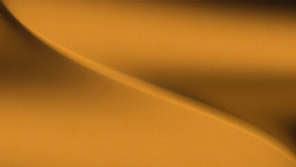 golden colored fabric with a smooth texture. Curves or waves on the surface of the fabric. Dynamic play of light and shadow on a luxurious gold background