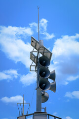 Emergency Broadcast System Tower with Solar Panels under Blue Sky