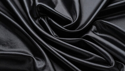 Obraz premium Luxurious black silk satin fabric with a smooth, soft, and elegant rippled texture for a fashionable backdrop