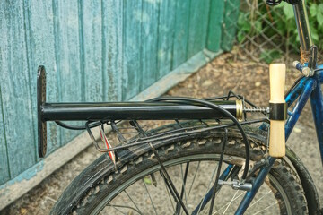 Fototapeta premium one black pump with hose lies on the bike rack on a summer street