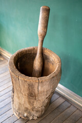 Traditional wooden mortar and pestle in a rustic setting