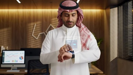 Arab businessman using futuristic smartwatch in modern office - Powered by Adobe