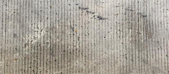 Grungy concrete road texture with parallel grooves