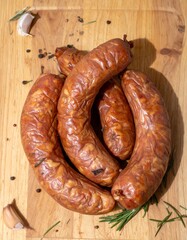 Various sausages arranged on a cutting board. Prepared for grilling in the garden on a sunny summer...