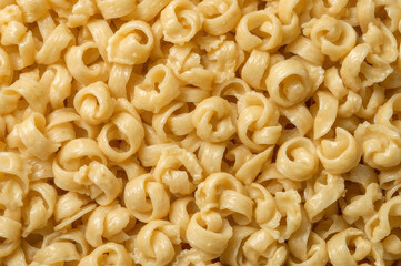 Golden Fusilli Pasta Texture Background for Culinary Arts, Food Production, and Italian Cuisine