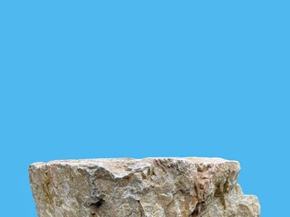 Stone podium rock stand isolated on cyan background with clipping path for product display presentation backdrop.
