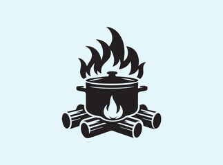 Boiling pot over a fire pit with visible wood and flames