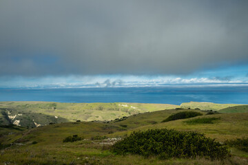 Green Foothills in front of Blue Pacific Ocean