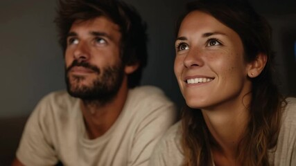 Joyful couple enjoying togetherness and sharing laughter in a warm, intimate setting