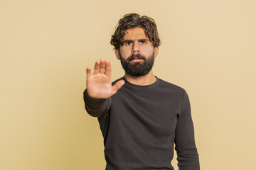 Indian man says No hold palm in stop gesture, warning of finish, prohibited access, declining...