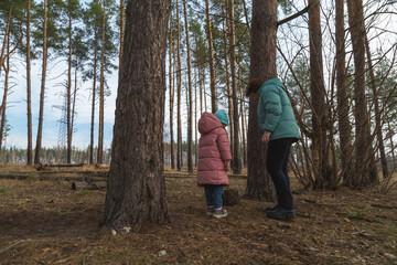 Obraz premium Grandmother and granddaughter walking in the forest