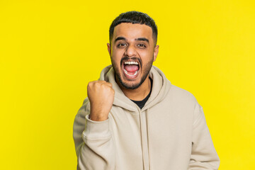 Happy joyful Indian man celebrating success victory, winning birthday, lottery jackpot goal...