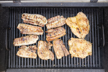 Delicious grilled chicken and sausages sizzling on a barbecue grill, showcasing the joy of cooking...