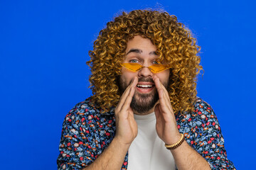 Keep my secrets, silence. Man with curly hairstyle wig whisper news rumors holding hands near mouth...