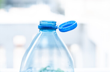 Plastic cap connected to a plastic bottle. Bottle design with the cap attached to the bottle for...
