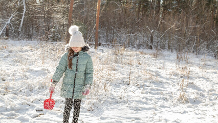 Playful family enjoying snowball fight in snowy winter park