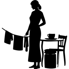 Woman hanging laundry while standing next to a table with a cup  