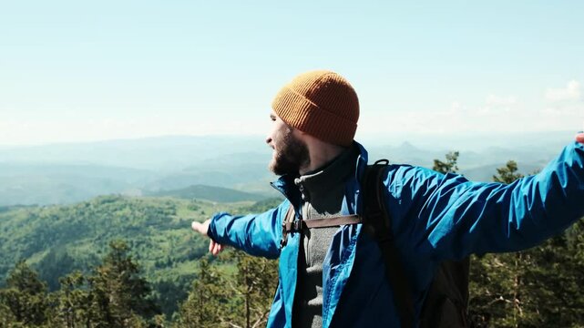 Happy tourist stretching arms wide for a selfie, enjoying the scenic view from Tornik peak. Serbia country during spring. Travel blogger making video outdoor. Horizontal 4k footage