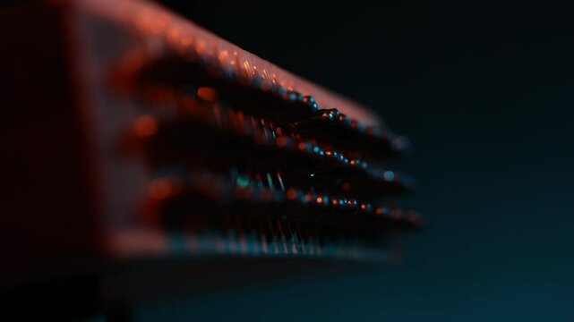 Cinematic macro close-up of a traditional wooden stringed instrument. Slow focus pull along tuning pegs and strings under dramatic red and teal lights, creating a moody atmosphere.