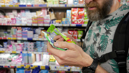 A male customer choosing sweets in a grocery store