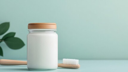 Homemade toothpaste in glass jar beside bamboo toothbrush and floss