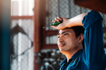 Factory Worker Feeling Tired, Hard Working Asian Garage Worker Standing in Hot Weather at...