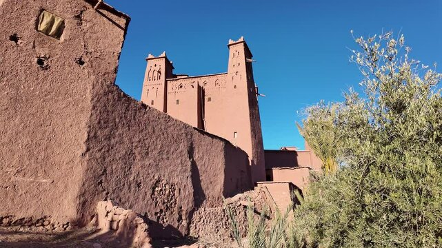 Ouarzazate, Morocco: Pan footage of the kasbah in the A&iuml;t Benhaddou fortified village near Ouarzazate in the Moroccan atlas with a dark blue sky. 