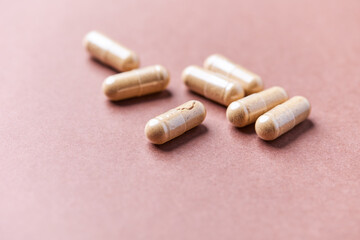 Korean Ginseng capsules. Concept for a healthy dietary supplementation. Bright paper background. Close up.	