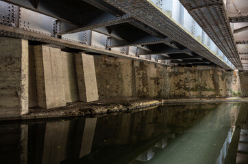 Underside of the railway bridge where the Great Western Main Line crosses the Grand Union Canal in Hayes, West London, UK.
